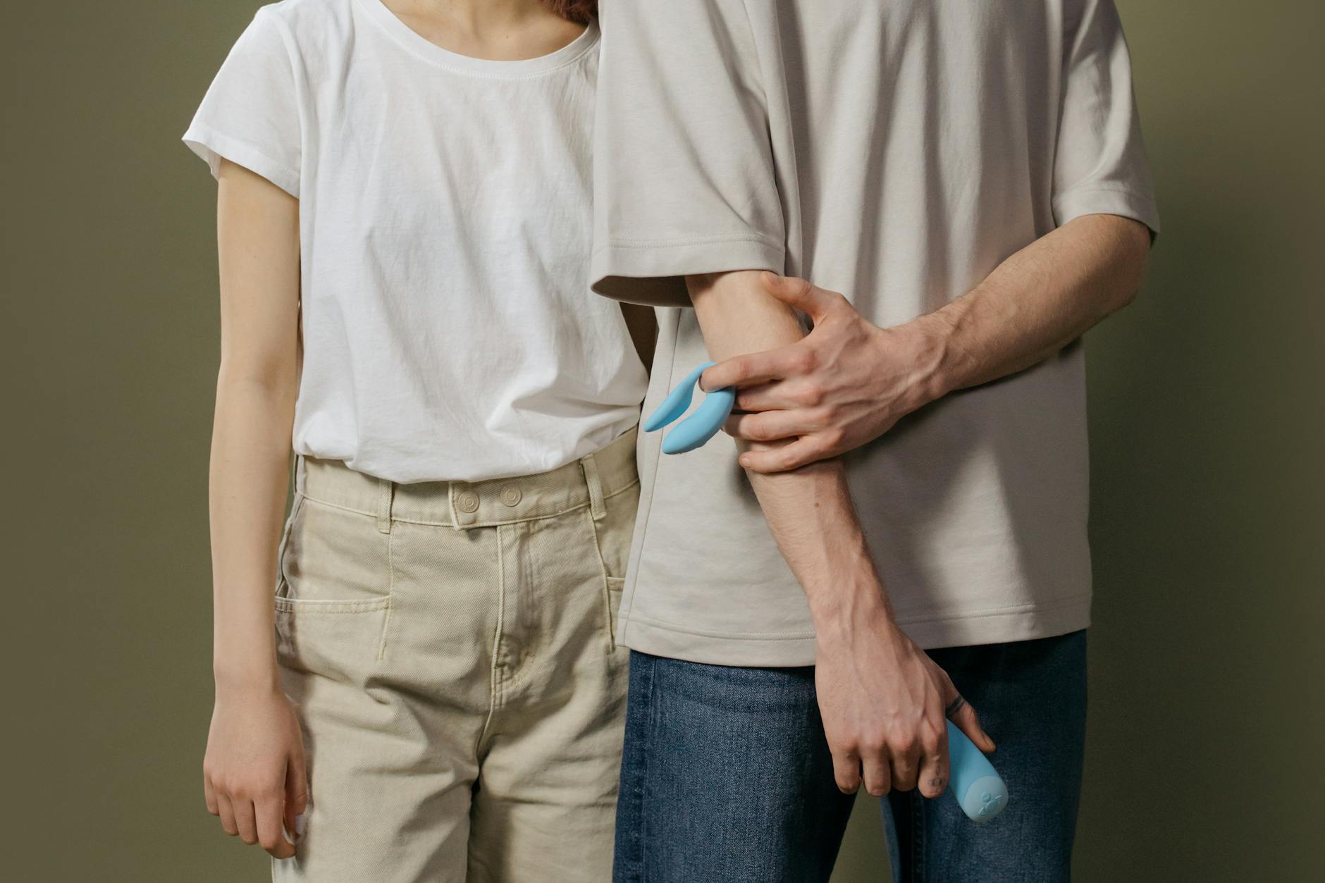 A couple exploring intimacy together with a modern clitoral vibrator, symbolizing open communication about pleasure