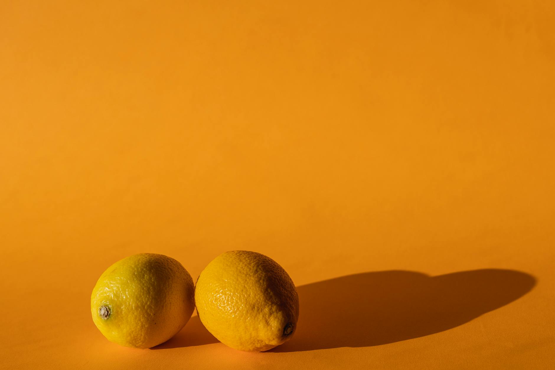 Ripe vivid lemons on bright yellow background symbolizing openness and fresh connection